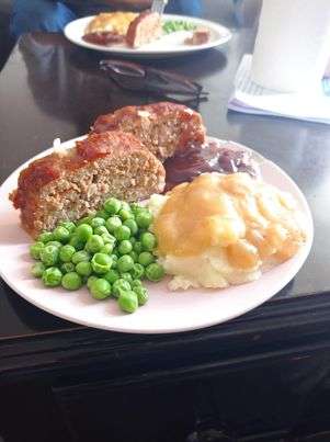 Meatloaf slices on a plate with a side of potatoes